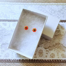 Load image into Gallery viewer, Two miniature pumpkin stud earrings inside a white paper jewelry box
