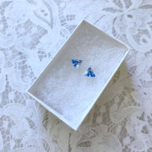 Load image into Gallery viewer, A pair of triangular blue white and silver earrings in a white paper jewelry box
