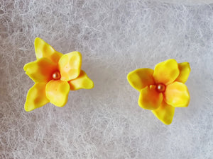 A pair of yellow and orange daylily earrings.