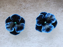 Load image into Gallery viewer, A pair of blue and black flower shaped earrings with blue metallic centers
