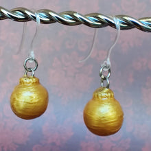 Load image into Gallery viewer, One pair of miniature gold baubles with a reflective textured surface. 
