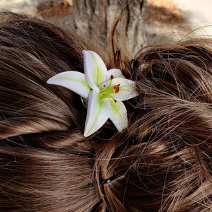Side view of a medium lily pin in a bun hair style. 