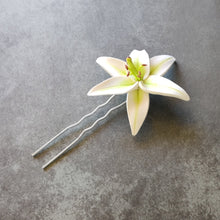 Load image into Gallery viewer, A single imitated white lily made of polymer clay on a two pronged hair pin.
