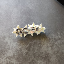 Load image into Gallery viewer, A back side view of the white lilies French hair clip. The Silver barrette is visible with the back of the petals visible behind it. 

