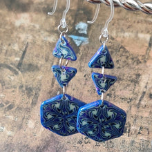 Load image into Gallery viewer, A pair of earrings made of two triangles and a hexagon dangle from two clear plastic ear hooks. 
